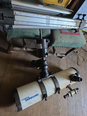 a machine that is sitting on the floor next to a piece of wood