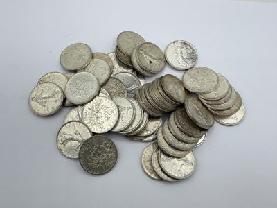 a pile of silver coins sitting on a table
