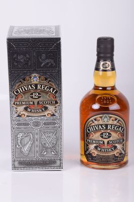 a close up of a bottle of chivas regal next to a box