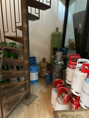 une pièce avec un escalier en colimaçon et de nombreuses bonbonnes de gaz propane