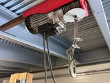 a crane hanging from the ceiling of a building