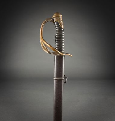 a close up of a sword with a gold handle on a black background