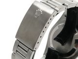a watch that is sitting on a white surface