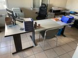 a desk with a computer on it in a room