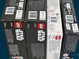 several boxes of lego star wars are stacked on top of each other