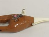 a toy gun with a horse on it sitting on a table
