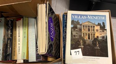 many books that are sitting in a box on the floor