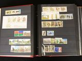an open book with stamps on it on a black surface