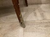 a wooden table with a vase on top of it