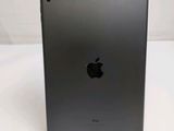 an apple ipad is sitting on a stand on a white surface