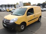 a yellow van parked in a parking lot next to other cars