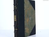 a black book with a green cover sitting on a table
