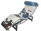 a black and white cowhide chaise lounger on a white background