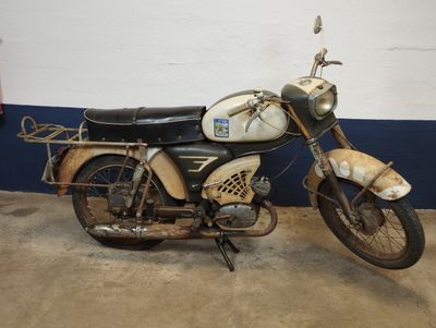 a old motorcycle that is parked in a garage