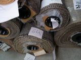 many rolls of fabric on the floor with price tags on them