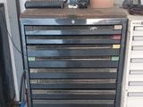 a metal tool cabinet with many drawers on it in a garage
