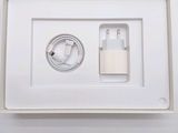 a white box with a charger and a cable in it