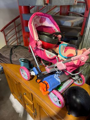 a baby stroller and other items on a dresser in a room