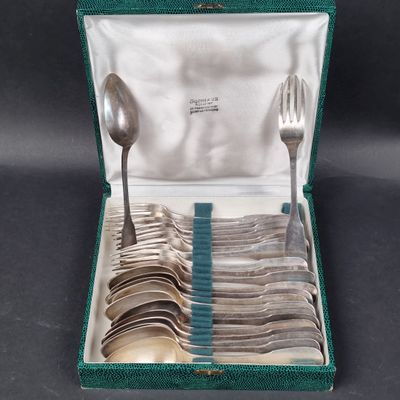 silverware in a green case with spoons and spoons in it