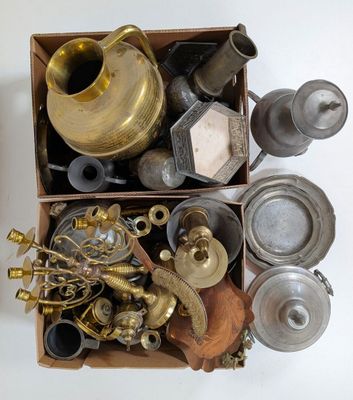 une boîte remplie d'objets en laiton posée sur une surface blanche
