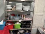 a kitchen with a bunch of dishes on a metal shelf