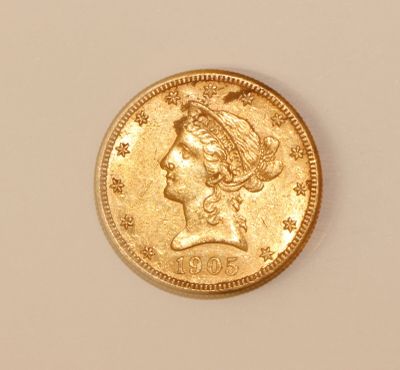 an image of a gold coin with a woman ' s head on it