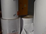 several rolls of toilet paper sitting on top of a wooden floor