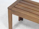 a wooden bench that is sitting on a white floor
