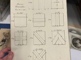 a person holding a piece of paper with drawings on it