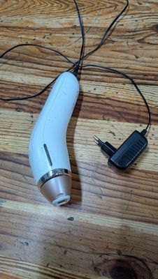 a hair dryer that is sitting on a wooden floor