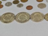 a lot of coins that are on the table