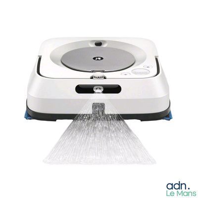 a white robot that is spraying water on the floor