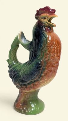 a colorful rooster figurine with a red hat on it