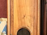 a tall wooden cabinet in the corner of a room