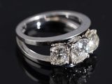 a close up of a diamond ring on a black surface