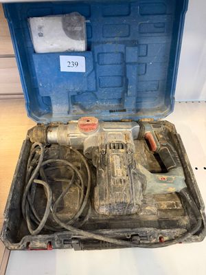 a tool box with a drill and a cord in it