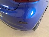 a close up of a blue car in a showroom