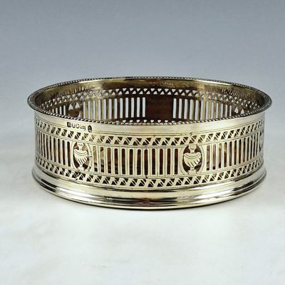 an antique silver plate with a design on the rim
