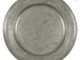 a silver plate with writing on it on a white surface