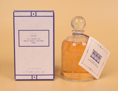a bottle of perfume sitting next to a box