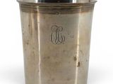 an antique silverplated cup with a monogram on the side
