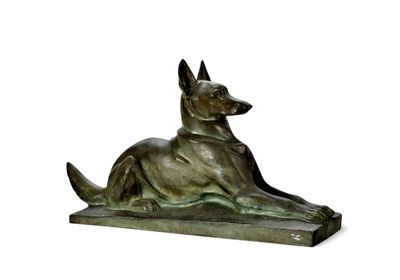 statue of a dog laying down on its side on a white surface