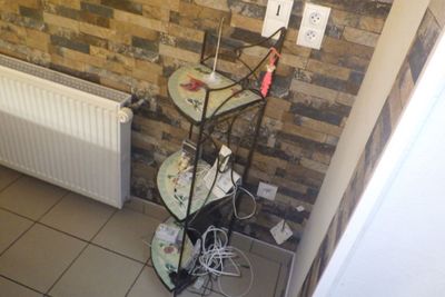 a picture of a corner of a room with a brick wall