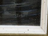a picture of a cat sitting in a window sill