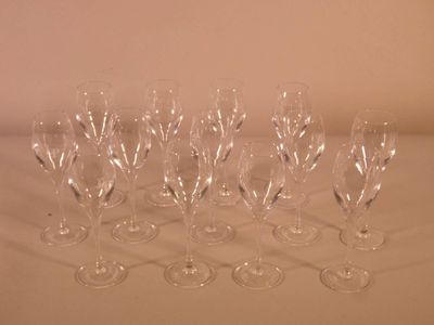 several empty wine glasses are lined up on a white surface
