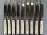 six knives with mother of pearl inlays on each of them
