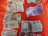 many different types of money laid out on a table
