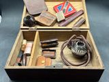 a wooden box filled with various items on a table
