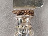 a silver spoon with a silver handle on a table
