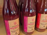 bottles of fruit juice on a shelf in a grocery store